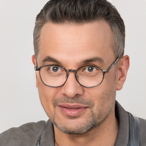 Joyful white adult male with short  brown hair and brown eyes