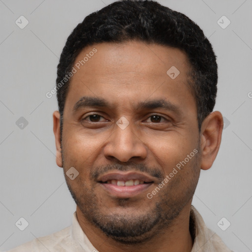 Joyful latino young-adult male with short  black hair and brown eyes