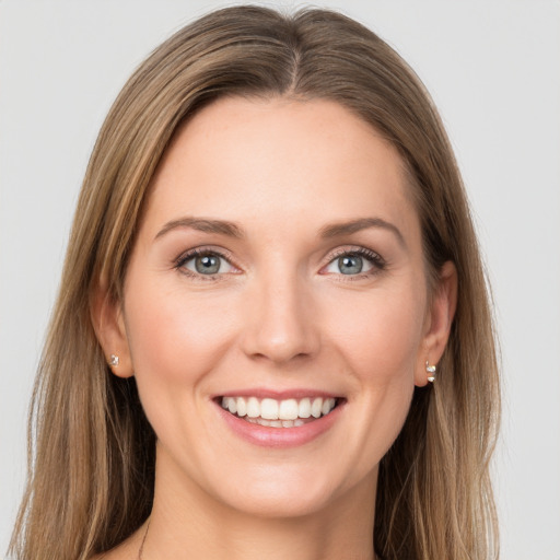 Joyful white young-adult female with long  brown hair and green eyes