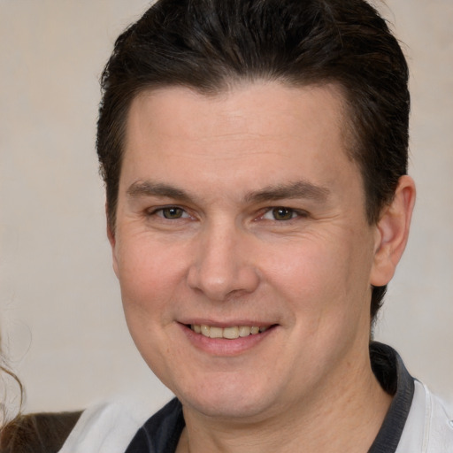 Joyful white young-adult male with short  brown hair and brown eyes