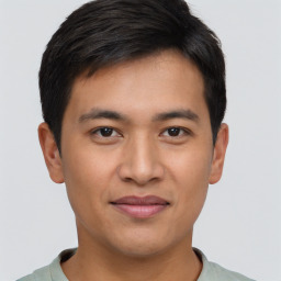 Joyful asian young-adult male with short  brown hair and brown eyes