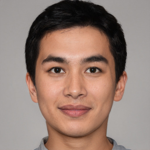 Joyful asian young-adult male with short  black hair and brown eyes