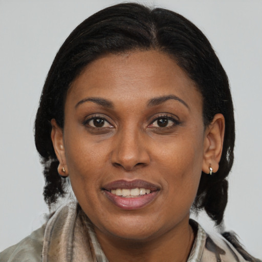 Joyful black young-adult female with medium  brown hair and brown eyes