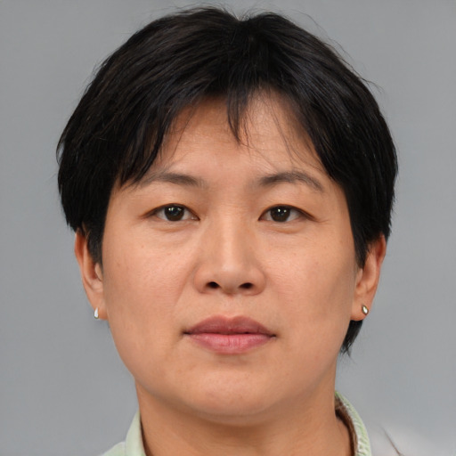 Joyful asian adult female with short  brown hair and brown eyes