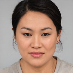 Joyful asian young-adult female with medium  brown hair and brown eyes