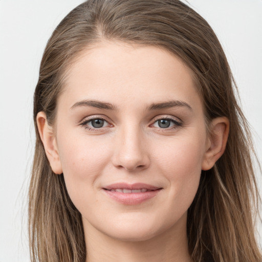 Joyful white young-adult female with long  brown hair and grey eyes