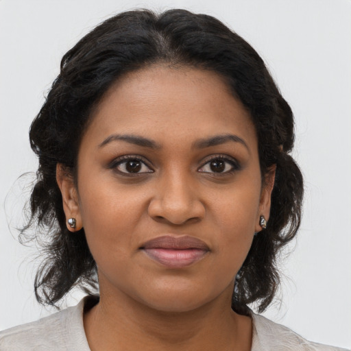 Joyful black young-adult female with medium  brown hair and brown eyes