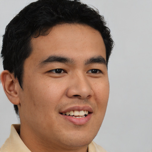 Joyful latino young-adult male with short  black hair and brown eyes