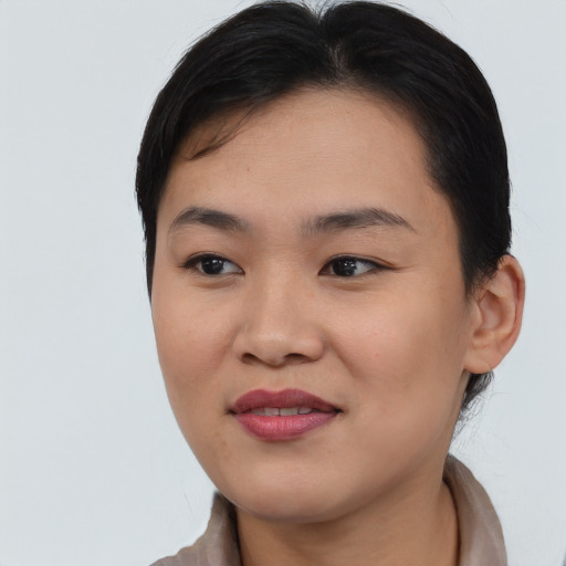 Joyful asian young-adult female with short  black hair and brown eyes