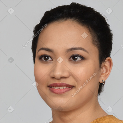 Joyful latino young-adult female with short  black hair and brown eyes