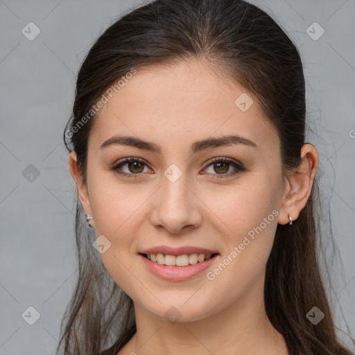 Joyful white young-adult female with long  brown hair and brown eyes