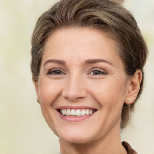 Joyful white adult female with short  brown hair and brown eyes