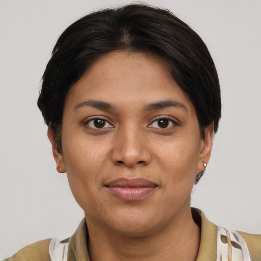 Joyful latino young-adult female with short  brown hair and brown eyes