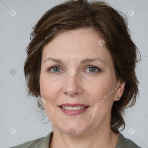 Joyful white adult female with medium  brown hair and grey eyes