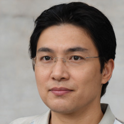 Joyful asian adult male with short  brown hair and brown eyes