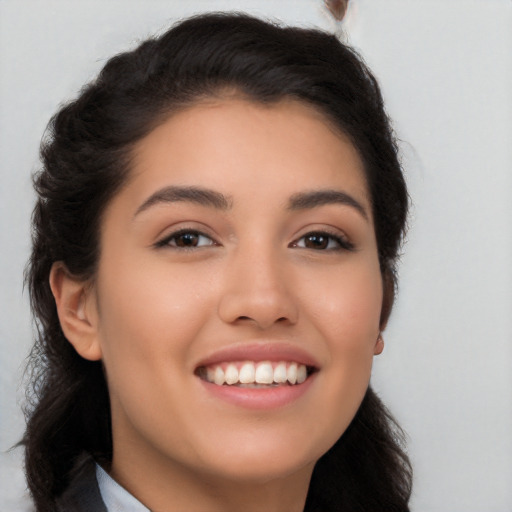 Joyful latino young-adult female with long  brown hair and brown eyes