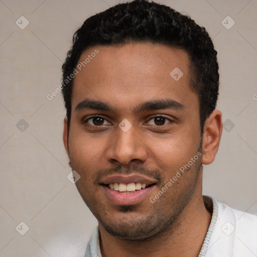 Joyful white young-adult male with short  black hair and brown eyes