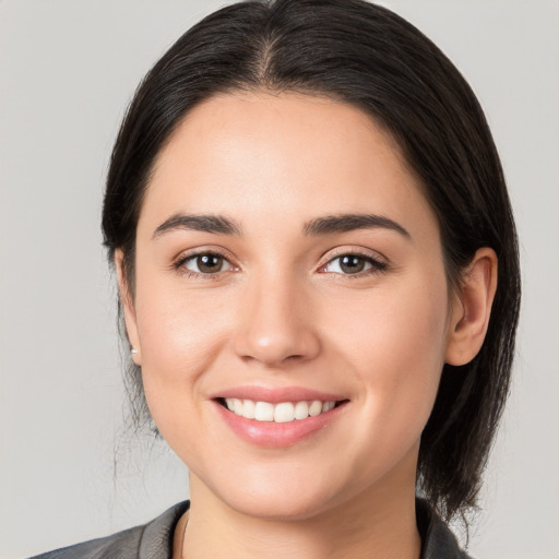 Joyful white young-adult female with medium  brown hair and brown eyes