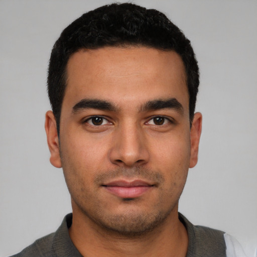 Neutral latino young-adult male with short  black hair and brown eyes