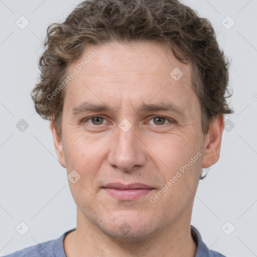 Joyful white adult male with short  brown hair and grey eyes