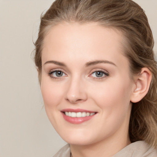 Joyful white young-adult female with long  brown hair and blue eyes