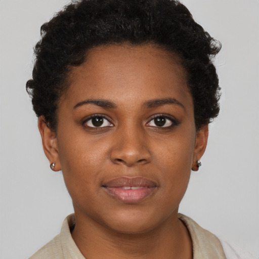 Joyful black young-adult female with short  brown hair and brown eyes