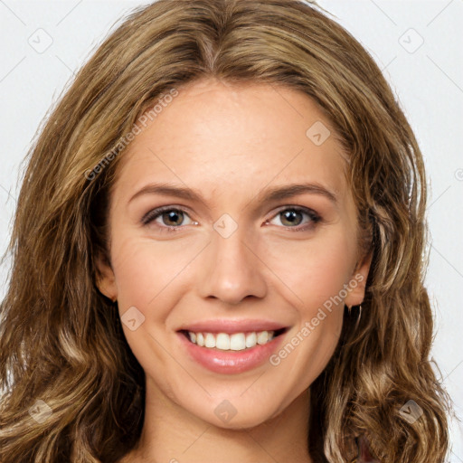 Joyful white young-adult female with long  brown hair and green eyes