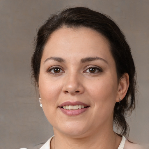 Joyful white adult female with medium  brown hair and brown eyes
