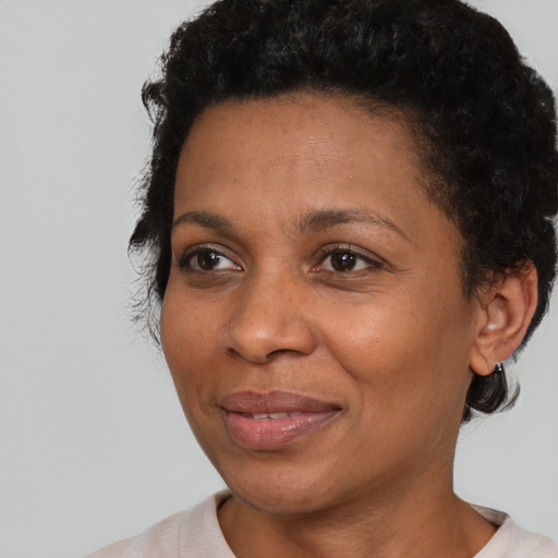Joyful black adult female with short  brown hair and brown eyes