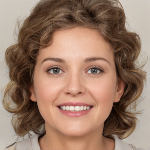 Joyful white young-adult female with medium  brown hair and green eyes