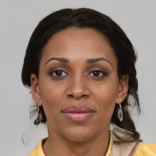 Joyful black young-adult female with medium  brown hair and brown eyes