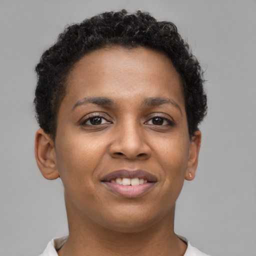 Joyful black young-adult female with short  brown hair and brown eyes