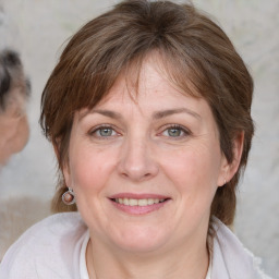 Joyful white adult female with medium  brown hair and grey eyes