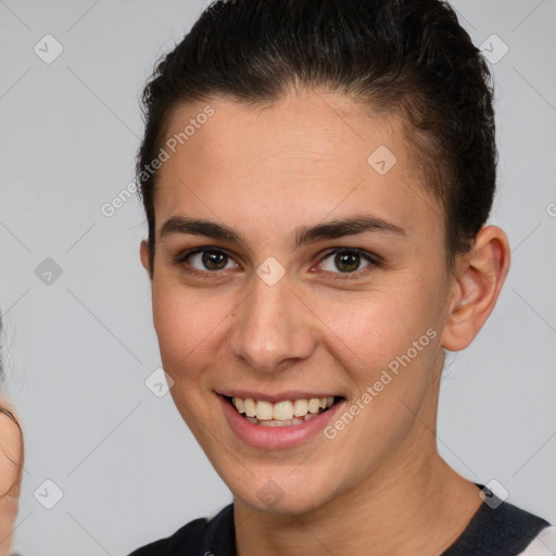 Joyful white young-adult female with short  brown hair and brown eyes