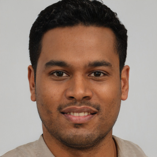 Joyful latino young-adult male with short  black hair and brown eyes