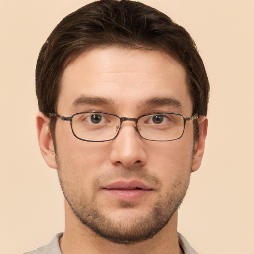 Joyful white young-adult male with short  brown hair and grey eyes