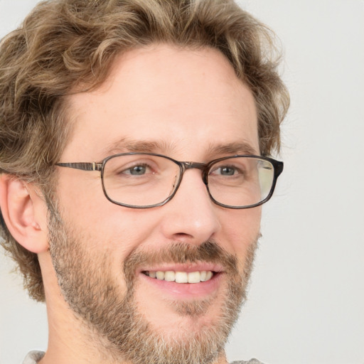 Joyful white adult male with short  brown hair and green eyes