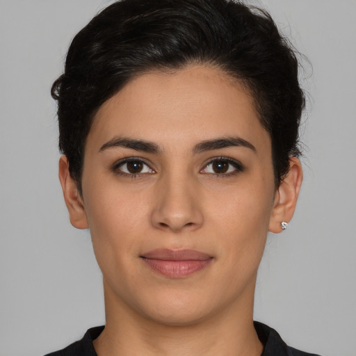 Joyful latino young-adult female with short  brown hair and brown eyes