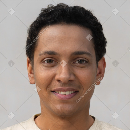 Joyful latino young-adult male with short  black hair and brown eyes