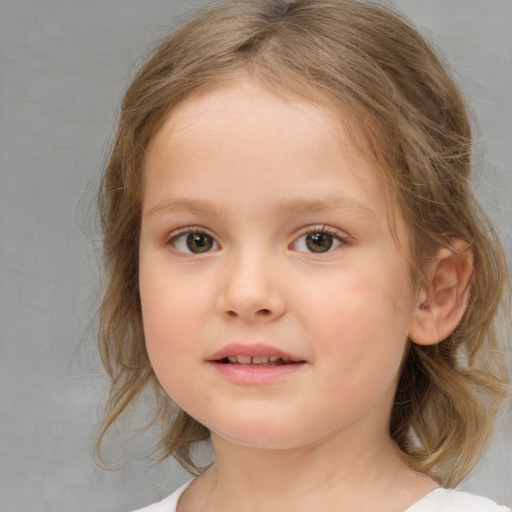 Joyful white child female with medium  brown hair and brown eyes