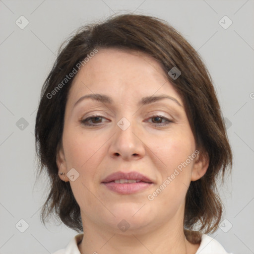 Joyful white adult female with medium  brown hair and brown eyes