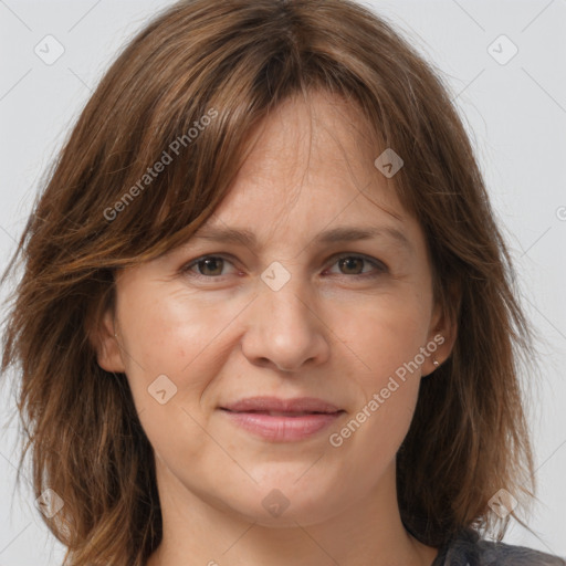 Joyful white adult female with medium  brown hair and grey eyes