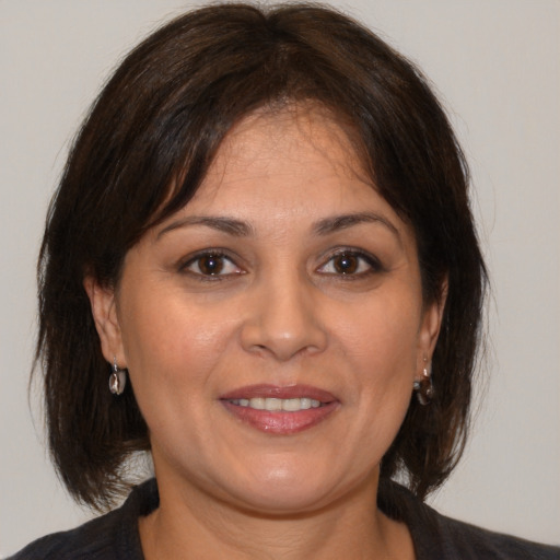 Joyful white adult female with medium  brown hair and brown eyes