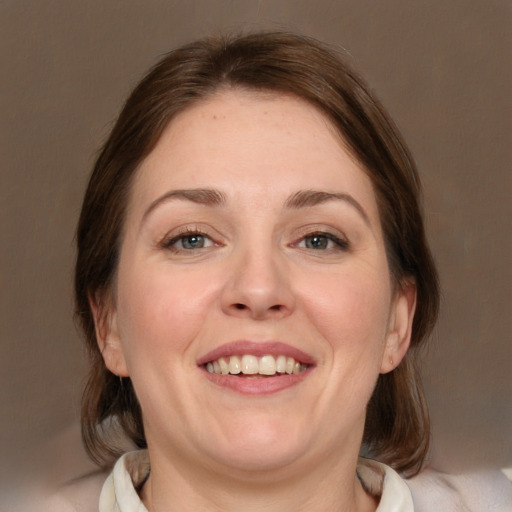 Joyful white young-adult female with medium  brown hair and grey eyes