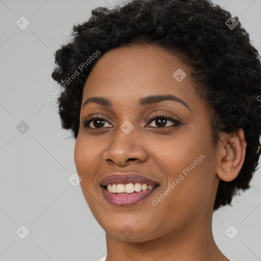 Joyful black young-adult female with short  black hair and brown eyes