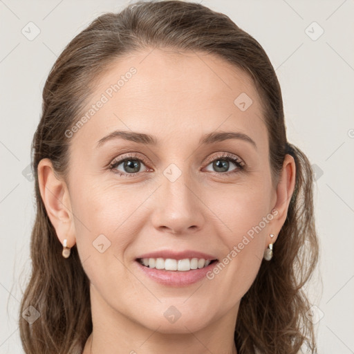 Joyful white young-adult female with long  brown hair and grey eyes