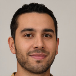 Joyful latino young-adult male with short  brown hair and brown eyes