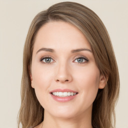 Joyful white young-adult female with long  brown hair and green eyes