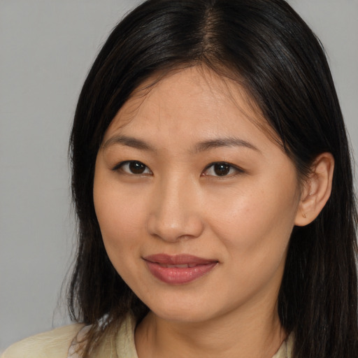 Joyful white young-adult female with medium  brown hair and brown eyes