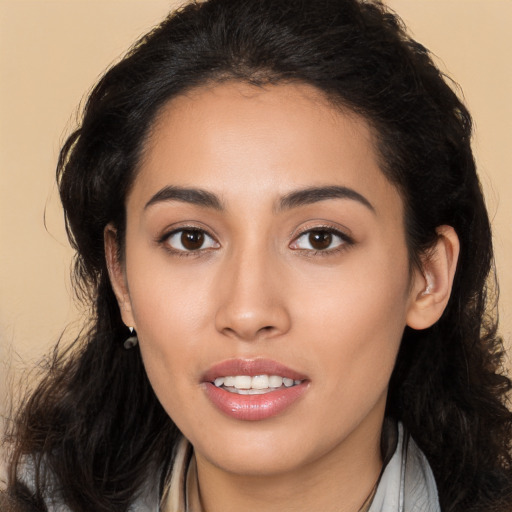 Joyful latino young-adult female with long  brown hair and brown eyes